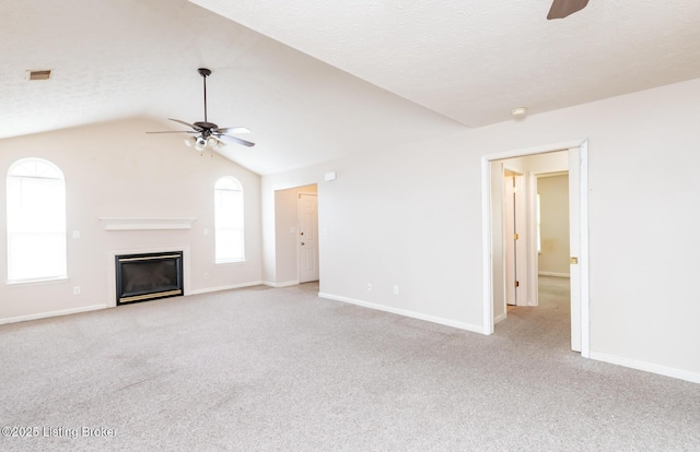 11330 Ridge Lake Dr, Louisville, KY 40272 - unfurnished living room with a ceiling fan, light colored carpet, a glass covered fireplace, vaulted ceiling, and baseboards