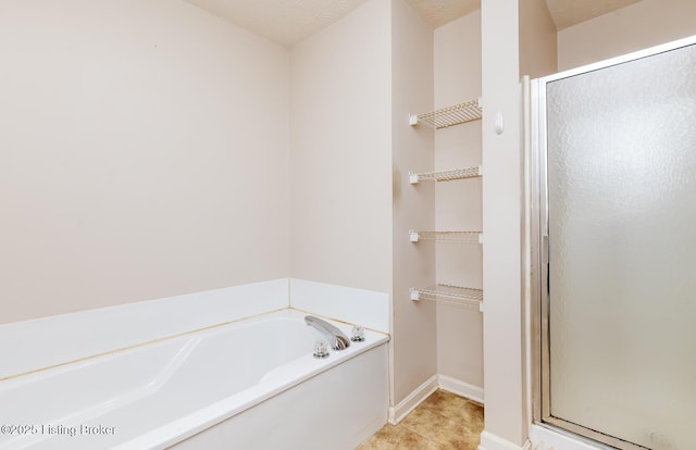 11330 Ridge Lake Dr, Louisville, KY 40272 - bathroom featuring a shower stall, a garden tub, and baseboards