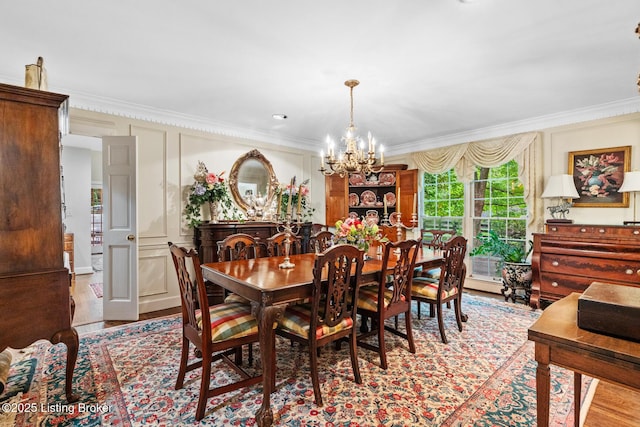12104 Locust Ln, Anchorage, KY 40223 - dining area featuring crown molding, a chandelier, and wood finished floors