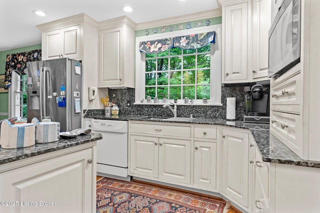 12104 Locust Ln, Anchorage, KY 40223 - kitchen with stainless steel fridge, white dishwasher, decorative backsplash, a sink, and dark stone counters