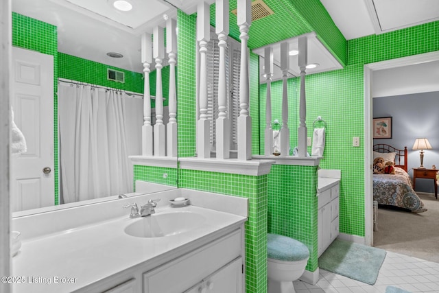 12104 Locust Ln, Anchorage, KY 40223 - full bath with tile walls, tile patterned floors, connected bathroom, toilet, and vanity