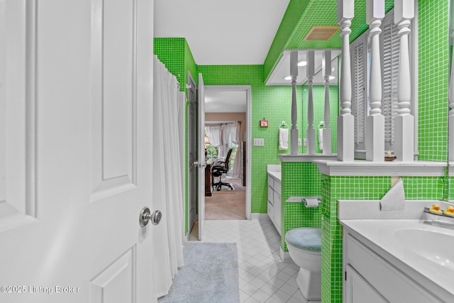12104 Locust Ln, Anchorage, KY 40223 - bathroom with tile patterned floors, vanity, toilet, and tile walls