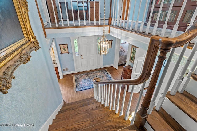 12104 Locust Ln, Anchorage, KY 40223 - entryway featuring wood finished floors, stairs, a chandelier, baseboards, and a towering ceiling