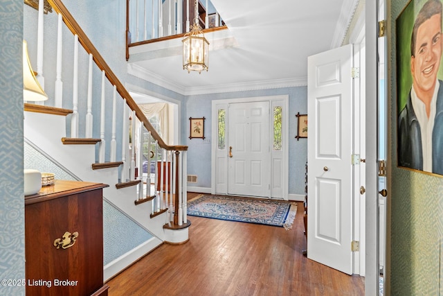 12104 Locust Ln, Anchorage, KY 40223 - foyer entrance with wood finished floors, a chandelier, ornamental molding, stairs, and baseboards