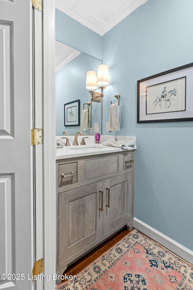 12104 Locust Ln, Anchorage, KY 40223 - bathroom featuring crown molding, vanity, baseboards, and wood finished floors