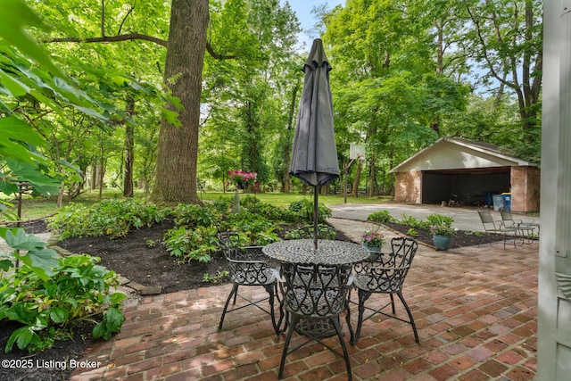12104 Locust Ln, Anchorage, KY 40223 - view of patio / terrace featuring a garage, an outbuilding, and outdoor dining space