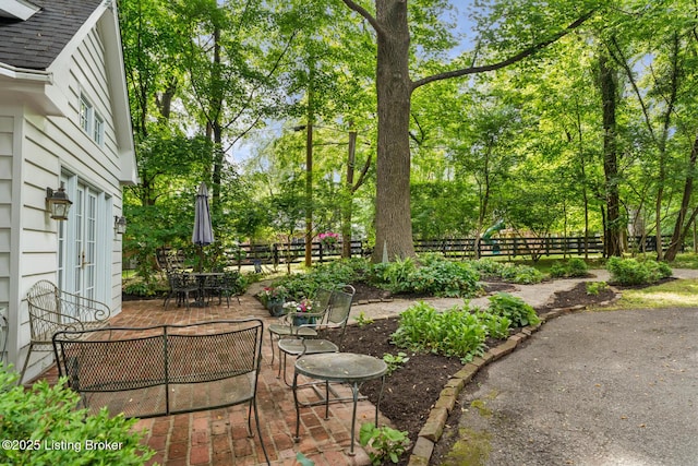 12104 Locust Ln, Anchorage, KY 40223 - view of yard featuring a patio area, french doors, outdoor dining area, and view of wooded area