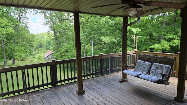 1250 Arnold School Rd, Webster, KY 40176 - deck featuring a ceiling fan, a lawn, and a forest view