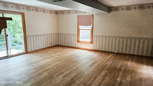 1250 Arnold School Rd, Webster, KY 40176 - spare room featuring wood-type flooring, wallpapered walls, and baseboards