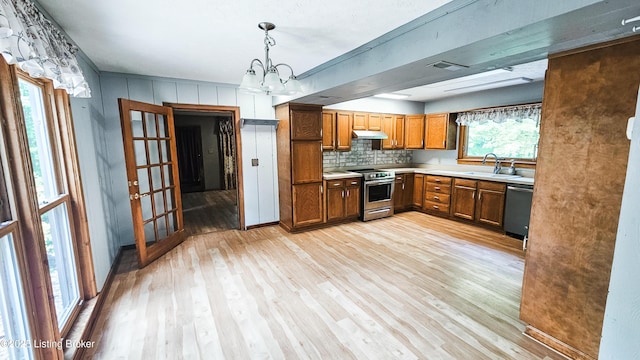 1250 Arnold School Rd, Webster, KY 40176 - kitchen with appliances with stainless steel finishes, a sink, brown cabinetry, and light wood finished floors