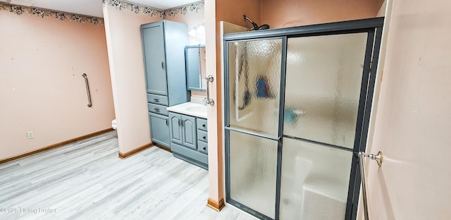 1250 Arnold School Rd, Webster, KY 40176 - bathroom with wood finished floors, a shower stall, vanity, toilet, and baseboards