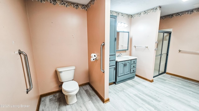 1250 Arnold School Rd, Webster, KY 40176 - full bathroom featuring wood finished floors, a shower stall, toilet, and baseboards