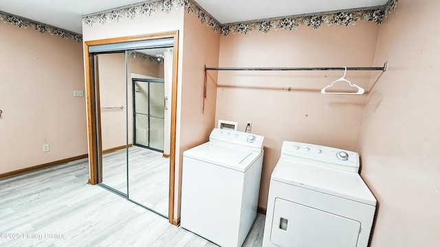 1250 Arnold School Rd, Webster, KY 40176 - laundry room with washing machine and dryer, light wood finished floors, and baseboards