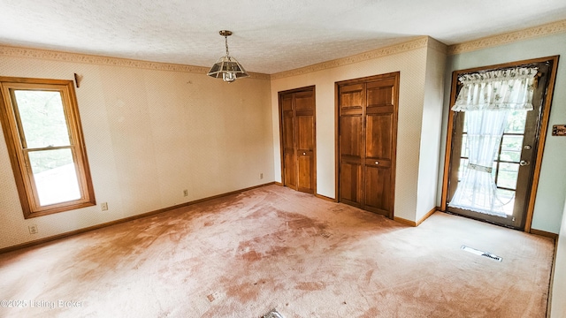 1250 Arnold School Rd, Webster, KY 40176 - unfurnished dining area with light carpet, plenty of natural light, baseboards, and a textured ceiling