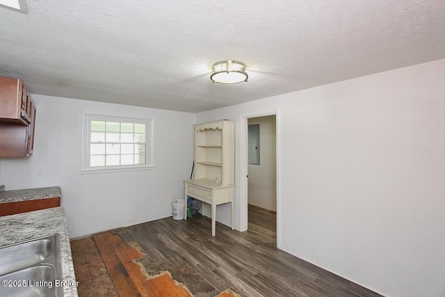 485 Hazzard St, Scottsburg, IN 47170 - unfurnished dining area with electric panel, dark wood-type flooring, a sink, and a textured ceiling