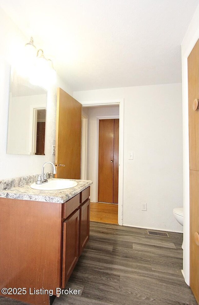 485 Hazzard St, Scottsburg, IN 47170 - bathroom with wood finished floors, vanity, and toilet