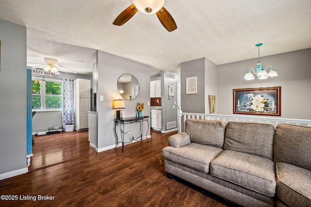 5202 Baywood Dr, Louisville, KY 40241 - living room with ceiling fan, a textured ceiling, dark wood finished floors, a chandelier, and baseboards