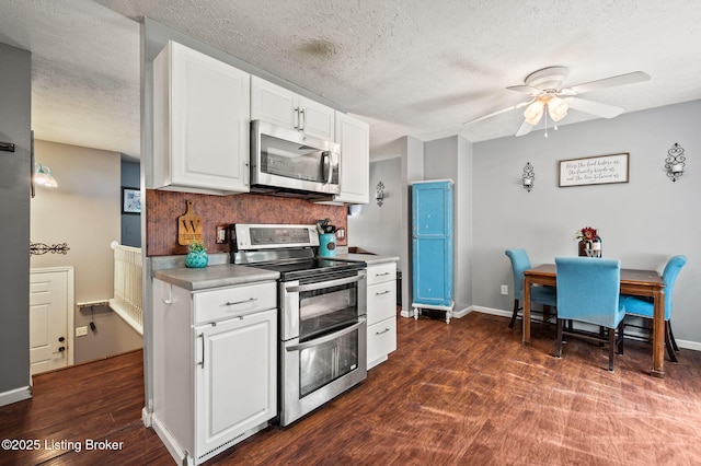 5202 Baywood Dr, Louisville, KY 40241 - kitchen featuring appliances with stainless steel finishes, ceiling fan, dark wood-type flooring, light countertops, and white cabinets