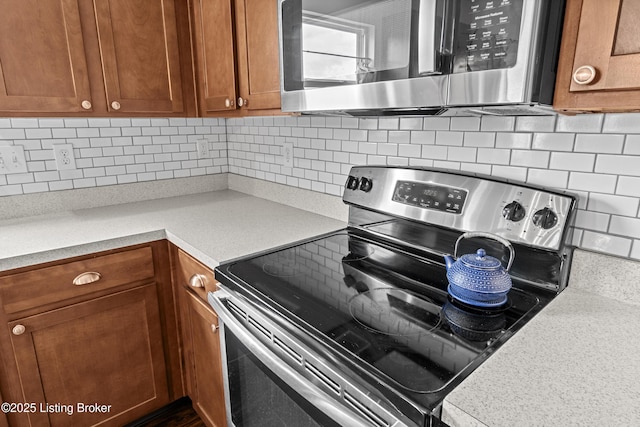 1130 Cherry Hollow Rd, La Grange, KY 40031 - kitchen with appliances with stainless steel finishes, tasteful backsplash, brown cabinetry, and light countertops