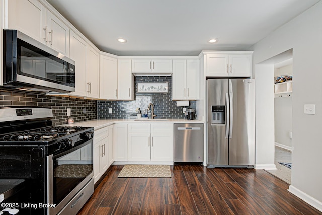 3400 Dell Rd, Louisville, KY 40299 - kitchen with appliances with stainless steel finishes, a sink, baseboards, dark wood-type flooring, and light countertops
