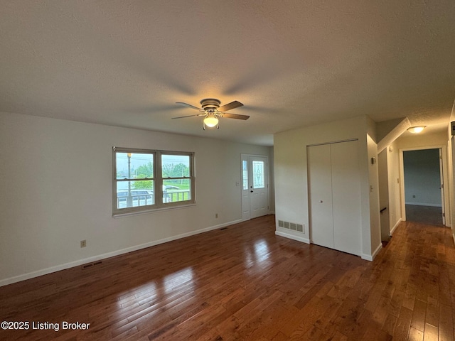 45 Paula Ct, Ekron, KY 40117 - unfurnished bedroom with a textured ceiling, dark wood finished floors, baseboards, a closet, and ceiling fan