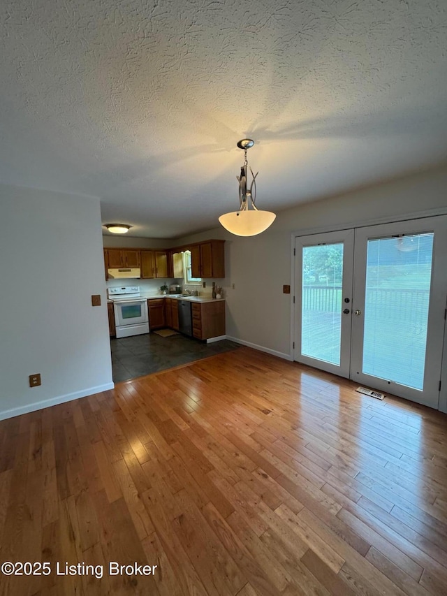 45 Paula Ct, Ekron, KY 40117 - unfurnished living room featuring a textured ceiling, baseboards, hardwood / wood-style floors, and french doors
