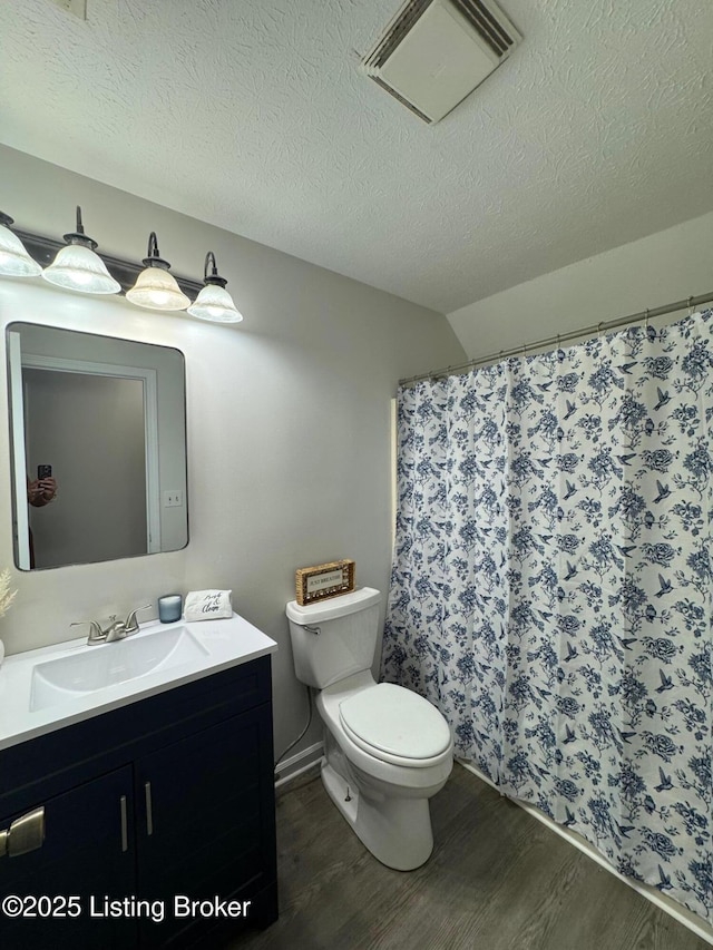 45 Paula Ct, Ekron, KY 40117 - full bathroom featuring wood finished floors, toilet, vanity, a textured ceiling, and curtained shower
