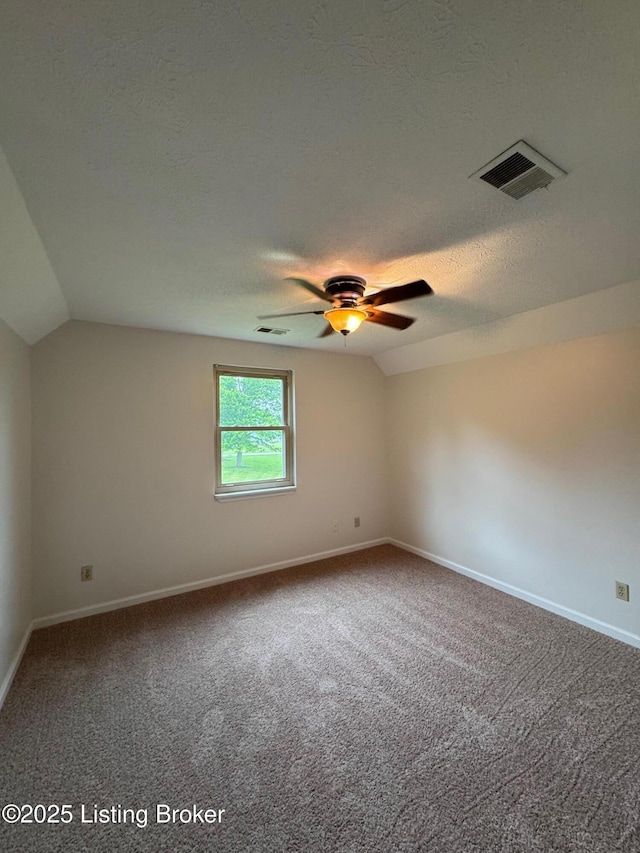 45 Paula Ct, Ekron, KY 40117 - spare room featuring vaulted ceiling, carpet, a ceiling fan, a textured ceiling, and baseboards