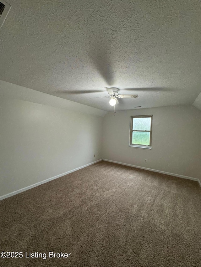 45 Paula Ct, Ekron, KY 40117 - empty room featuring carpet floors, baseboards, lofted ceiling, ceiling fan, and a textured ceiling