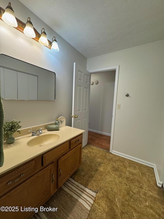 45 Paula Ct, Ekron, KY 40117 - bathroom featuring a textured ceiling, baseboards, vanity, and tile patterned floors