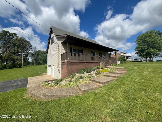 45 Paula Ct, Ekron, KY 40117 - view of front facade with covered porch, a front yard, driveway, and an attached garage