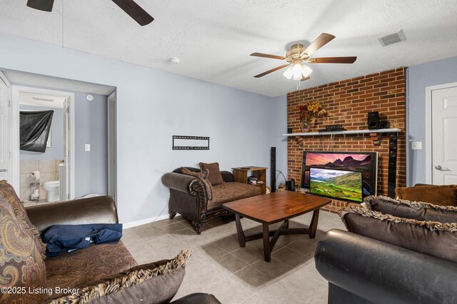 533 Wyandot Ct, Radcliff, KY 40160 - living area featuring ceiling fan, tile patterned flooring, a textured ceiling, a brick fireplace, and baseboards