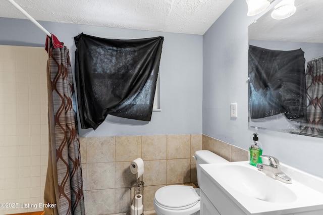 533 Wyandot Ct, Radcliff, KY 40160 - bathroom featuring a textured ceiling, tile walls, toilet, a shower with shower curtain, and vanity