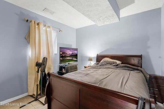 533 Wyandot Ct, Radcliff, KY 40160 - bedroom featuring light tile patterned flooring, a textured ceiling, and baseboards