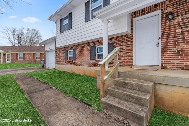 533 Wyandot Ct, Radcliff, KY 40160 - entrance to property featuring brick siding, driveway, and an attached garage