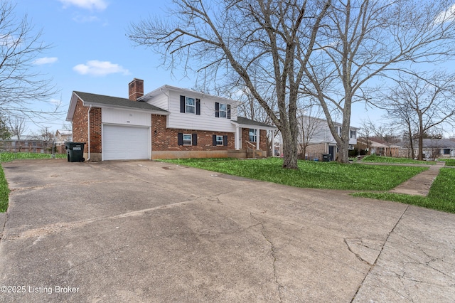 533 Wyandot Ct, Radcliff, KY 40160 - tri-level home featuring brick siding, concrete driveway, a garage, a chimney, and a front lawn