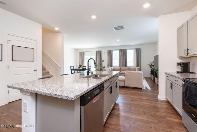 5806 Kellie Woods Dr, Louisville, KY 40258 - kitchen with stainless steel appliances, dark wood-type flooring, light stone countertops, a kitchen island with sink, and recessed lighting
