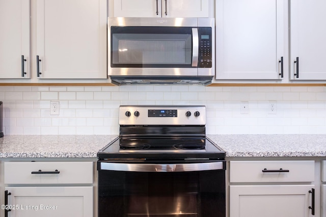 5806 Kellie Woods Dr, Louisville, KY 40258 - kitchen featuring appliances with stainless steel finishes, decorative backsplash, and light stone counters
