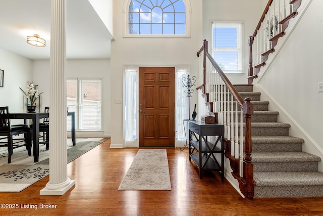 13512 Springs Station Rd, Louisville, KY 40245 - foyer with wood finished floors, stairs, a high ceiling, and decorative columns