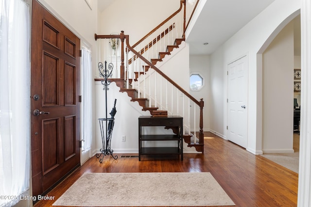 13512 Springs Station Rd, Louisville, KY 40245 - entrance foyer with wood finished floors, stairway, arched walkways, and baseboards