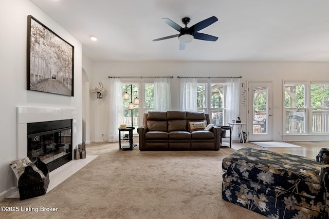 13512 Springs Station Rd, Louisville, KY 40245 - living area with a fireplace with flush hearth, ceiling fan, carpet floors, arched walkways, and baseboards