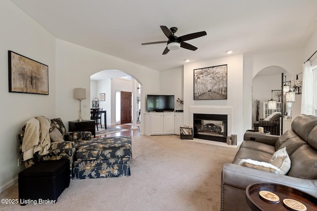 13512 Springs Station Rd, Louisville, KY 40245 - living area featuring arched walkways, ceiling fan, carpet, a glass covered fireplace, and baseboards