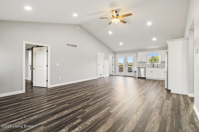 760 Leafdale Rd, Hodgenville, KY 42748 - unfurnished living room featuring ceiling fan, high vaulted ceiling, dark wood-type flooring, baseboards, and a sink