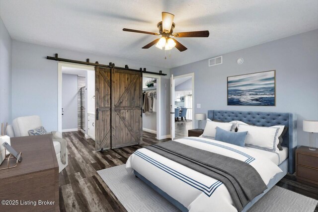 760 Leafdale Rd, Hodgenville, KY 42748 - bedroom featuring a barn door, wood finished floors, baseboards, a closet, and a ceiling fan