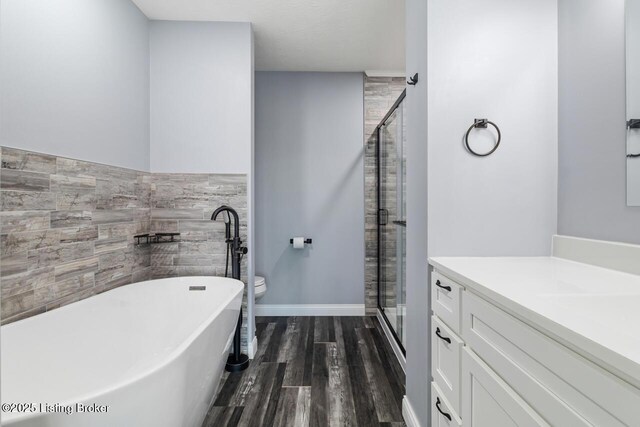 760 Leafdale Rd, Hodgenville, KY 42748 - full bathroom featuring a freestanding tub, wood finished floors, a stall shower, vanity, and tile walls