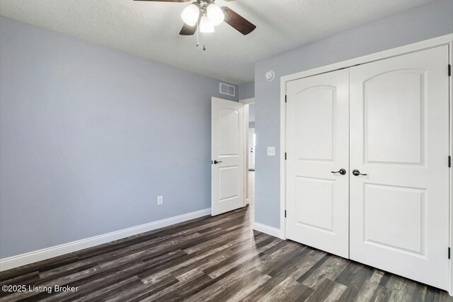 760 Leafdale Rd, Hodgenville, KY 42748 - unfurnished bedroom with dark wood finished floors, a closet, baseboards, and a ceiling fan