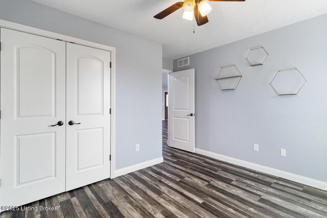 760 Leafdale Rd, Hodgenville, KY 42748 - unfurnished bedroom with baseboards, dark wood-style flooring, a closet, and a ceiling fan