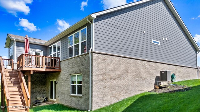 816 Snead Ct, Simpsonville, KY 40067 - back of house featuring brick siding, a deck, stairs, cooling unit, and a lawn