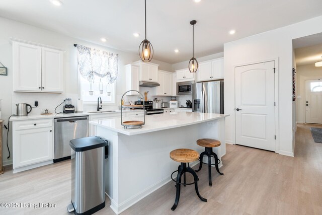 816 Snead Ct, Simpsonville, KY 40067 - kitchen featuring appliances with stainless steel finishes, a sink, white cabinetry, light wood finished floors, and recessed lighting
