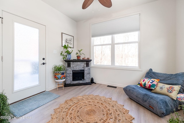 816 Snead Ct, Simpsonville, KY 40067 - living area with wood finished floors, ceiling fan, a fireplace, and baseboards